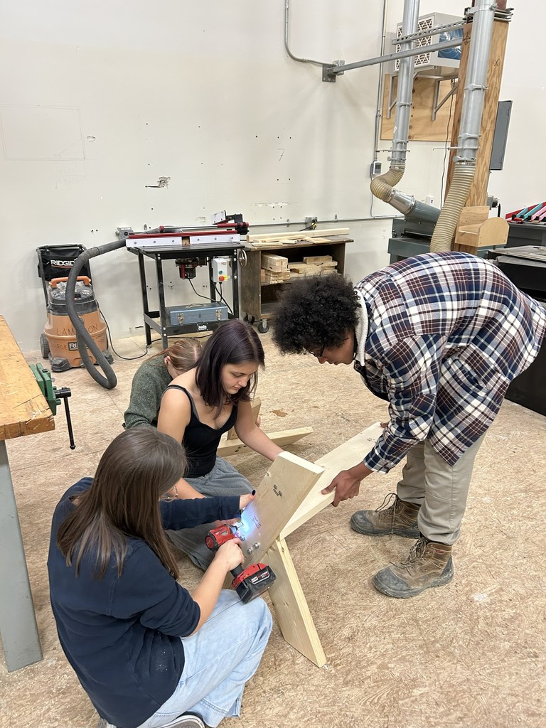 Students constructing a bench.