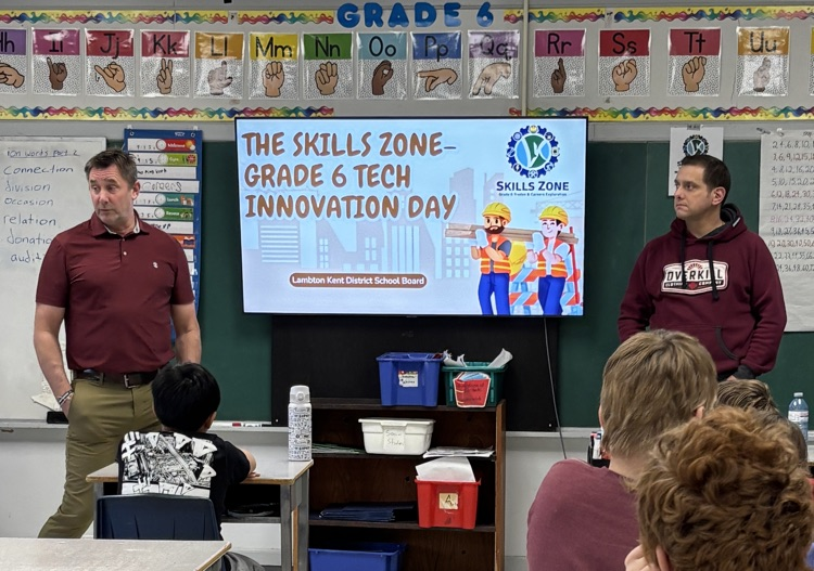 two teachers talking to students from the front of our classroom