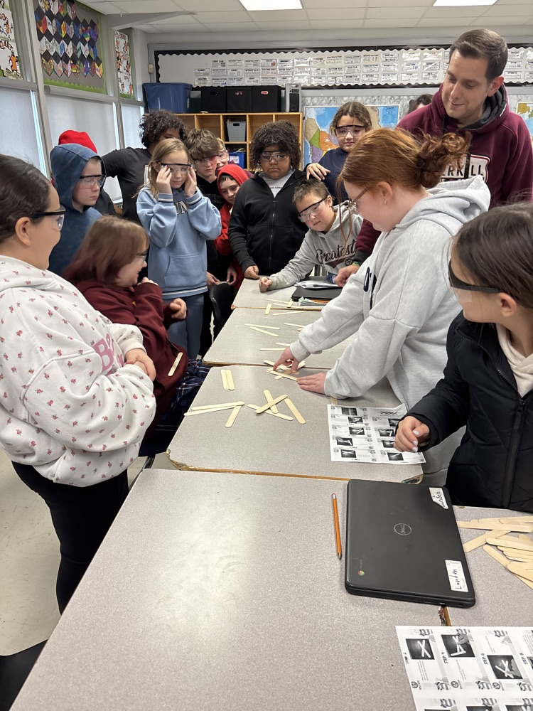Students working on project using popsicle sticks