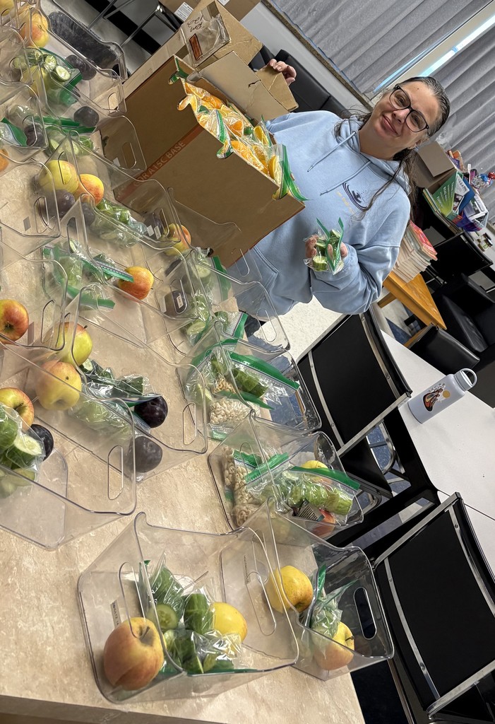 Ms. Tamming preparing snack bins. 