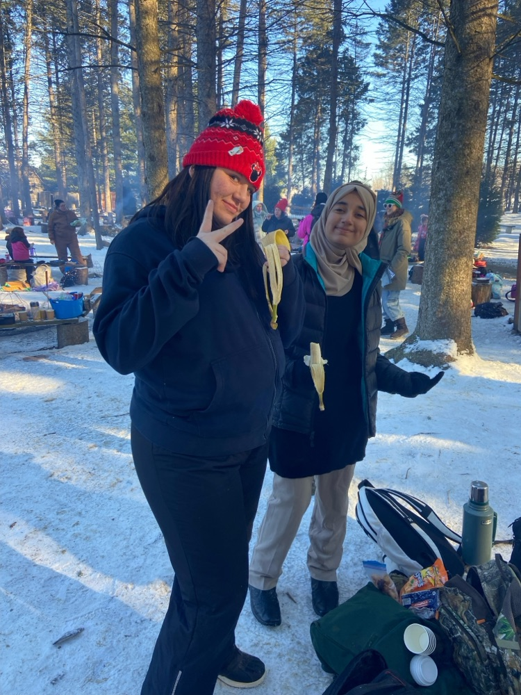 Students roasting marshmallows on a campfire