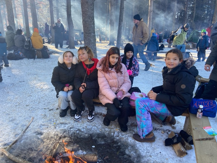 Student sitting around a camp