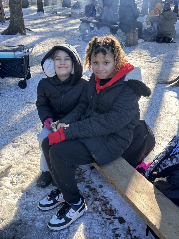 Student sitting around the campfire