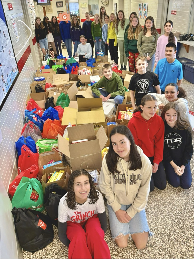kids with food drive donation pile