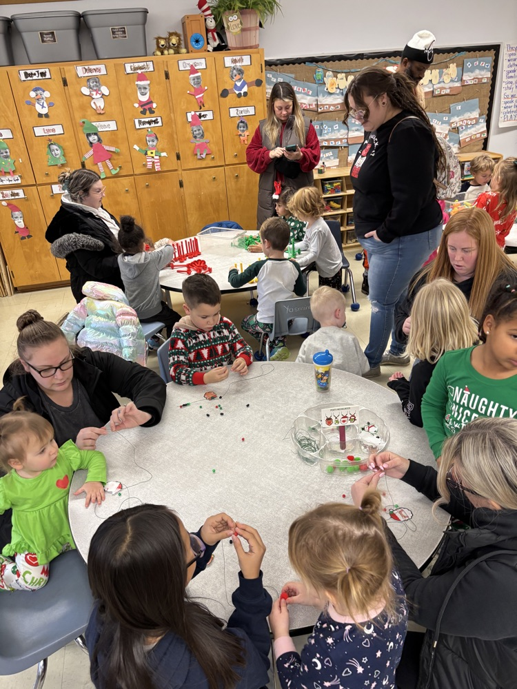 Parents doing activities with their children and a kindergarten room