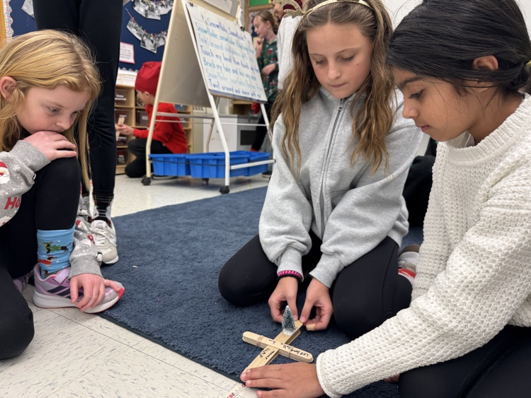 kids testing a popsicle stick catapult 