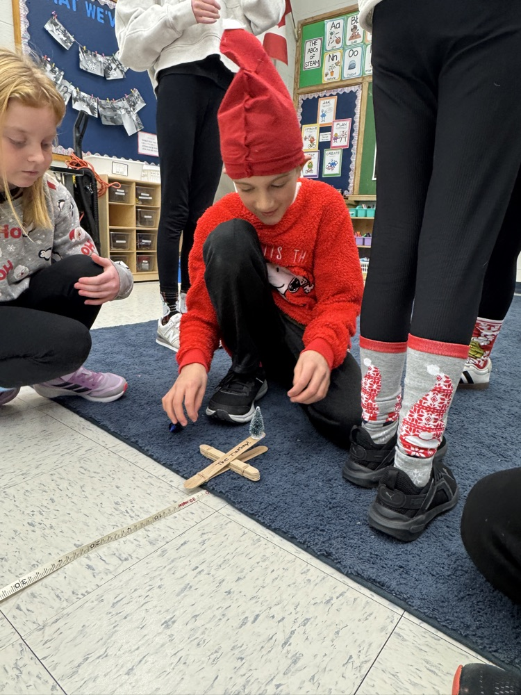 kids testing a popsicle stick catapult 