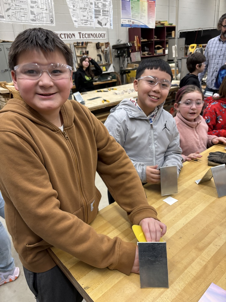 students applying decals to their sheet metal