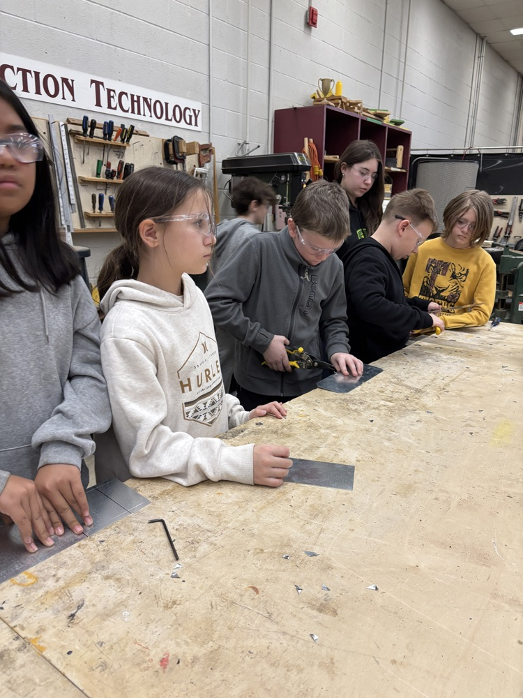 students using snips to cut sheet metal