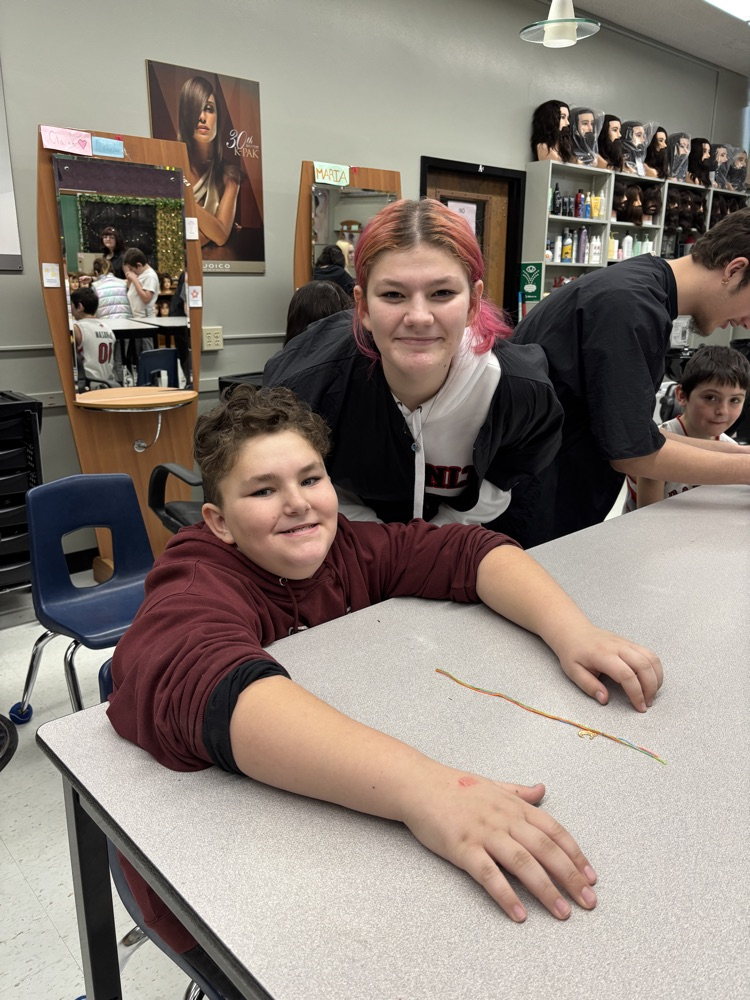 Students learning how to braid