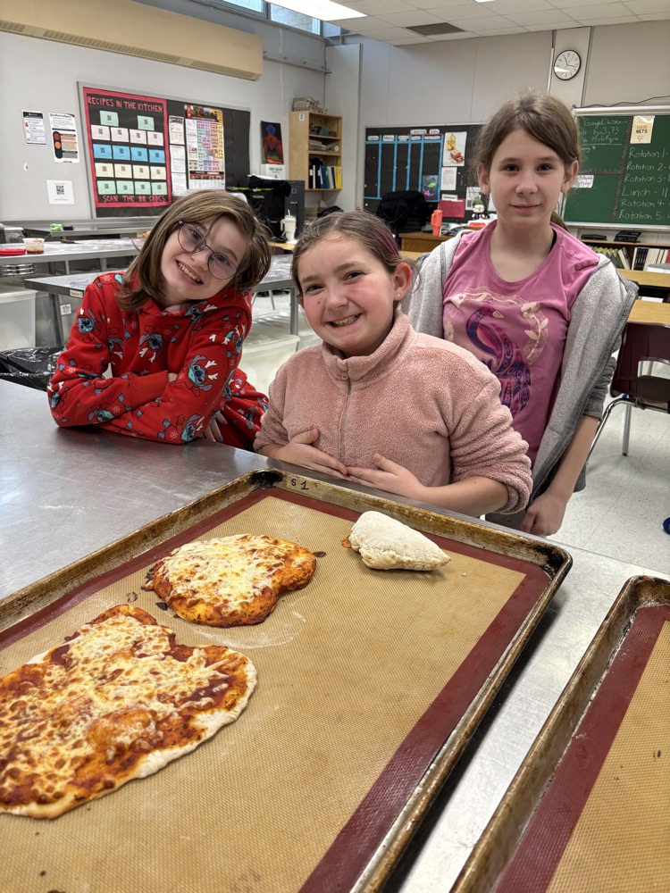 Student students making personal pizzas