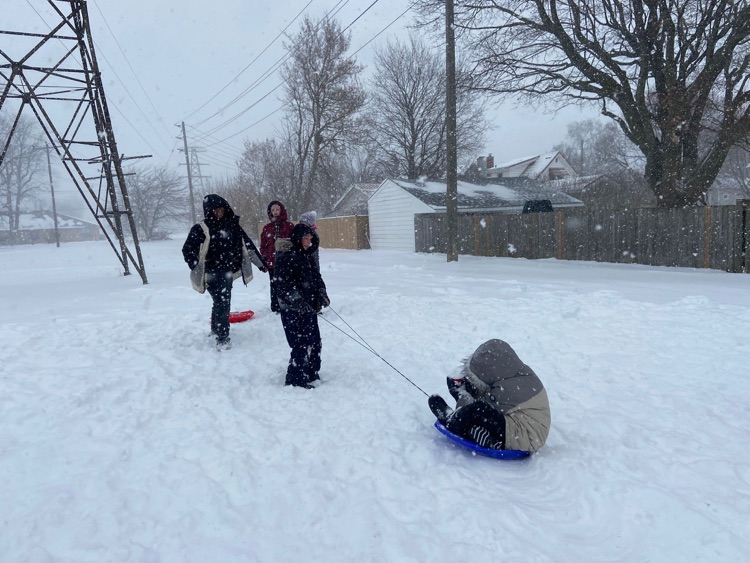 children pulling each other on a sled
