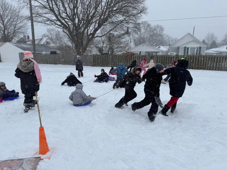 children having races, pulling each other on sleds