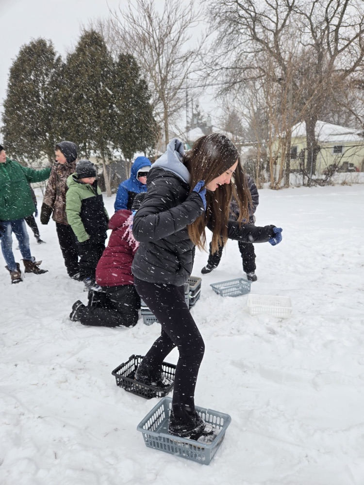 Children attempting to snowshoe
