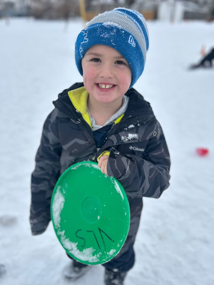 Child playing frisbee golf in the snow