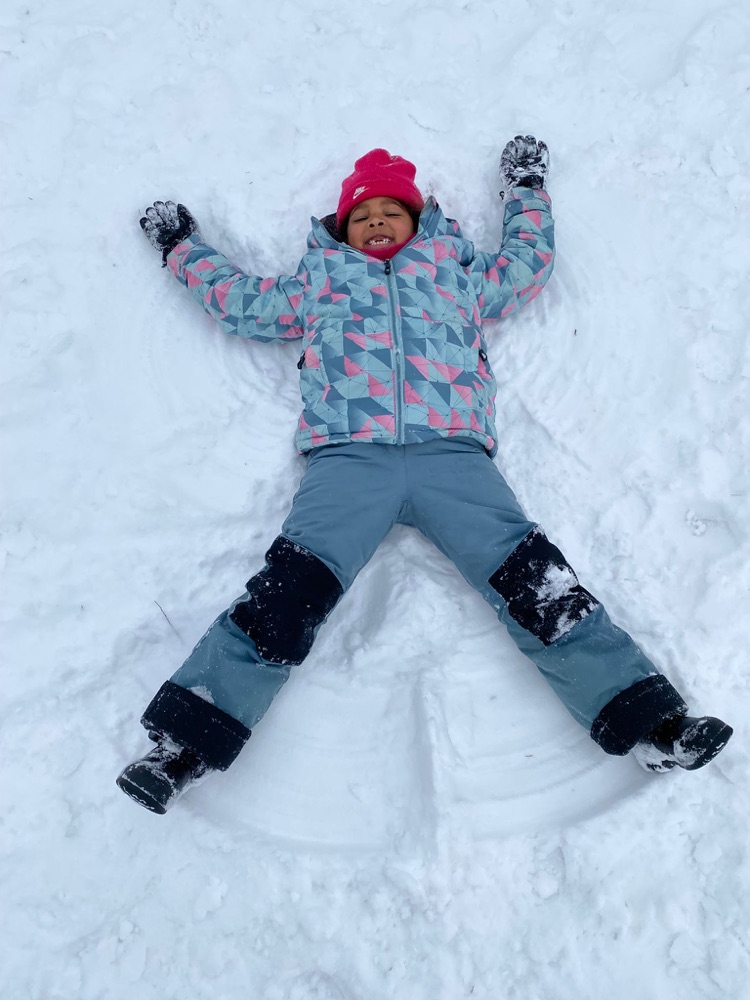 Child making a snow angel