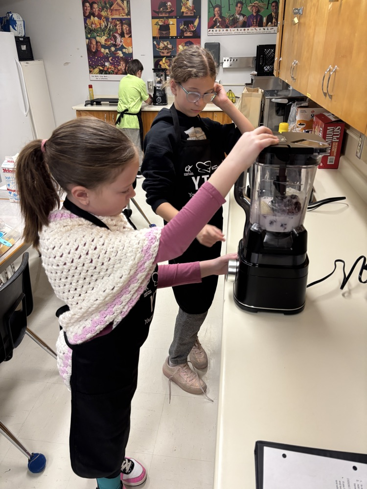 Students preparing a smoothie with a blender