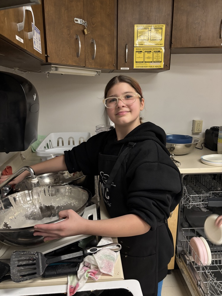 Student washing dishes