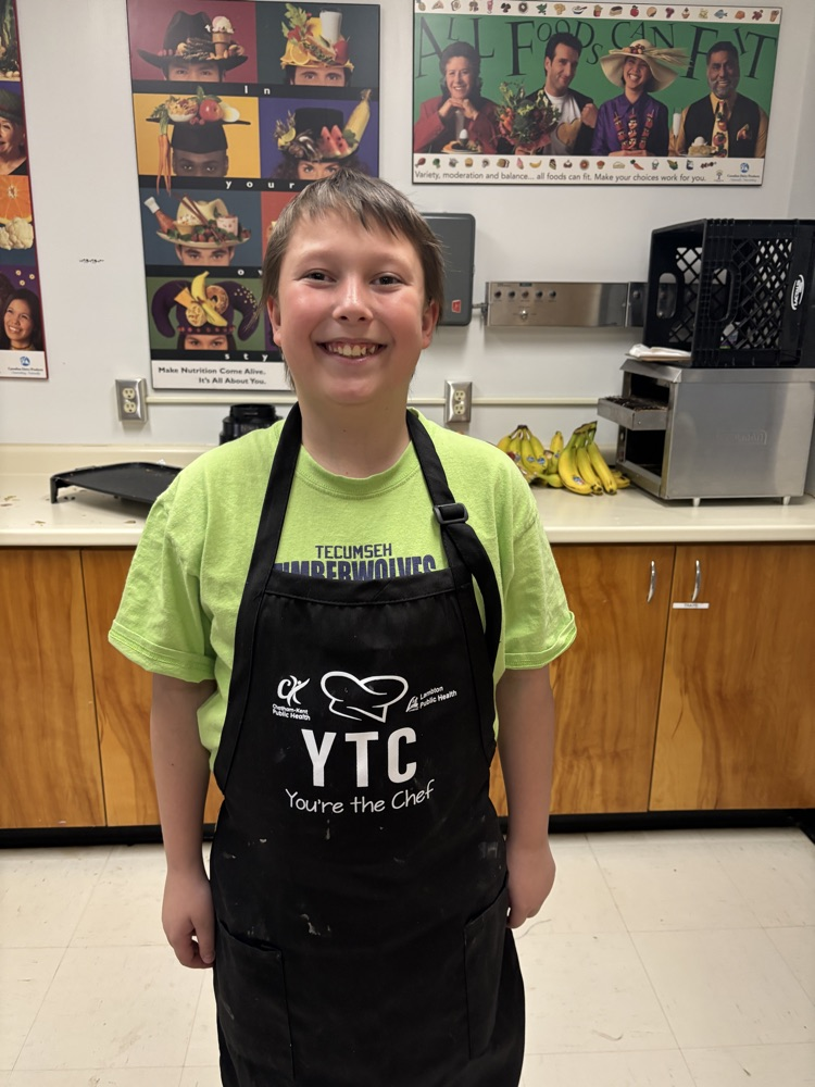 Student smiling in a kitchen