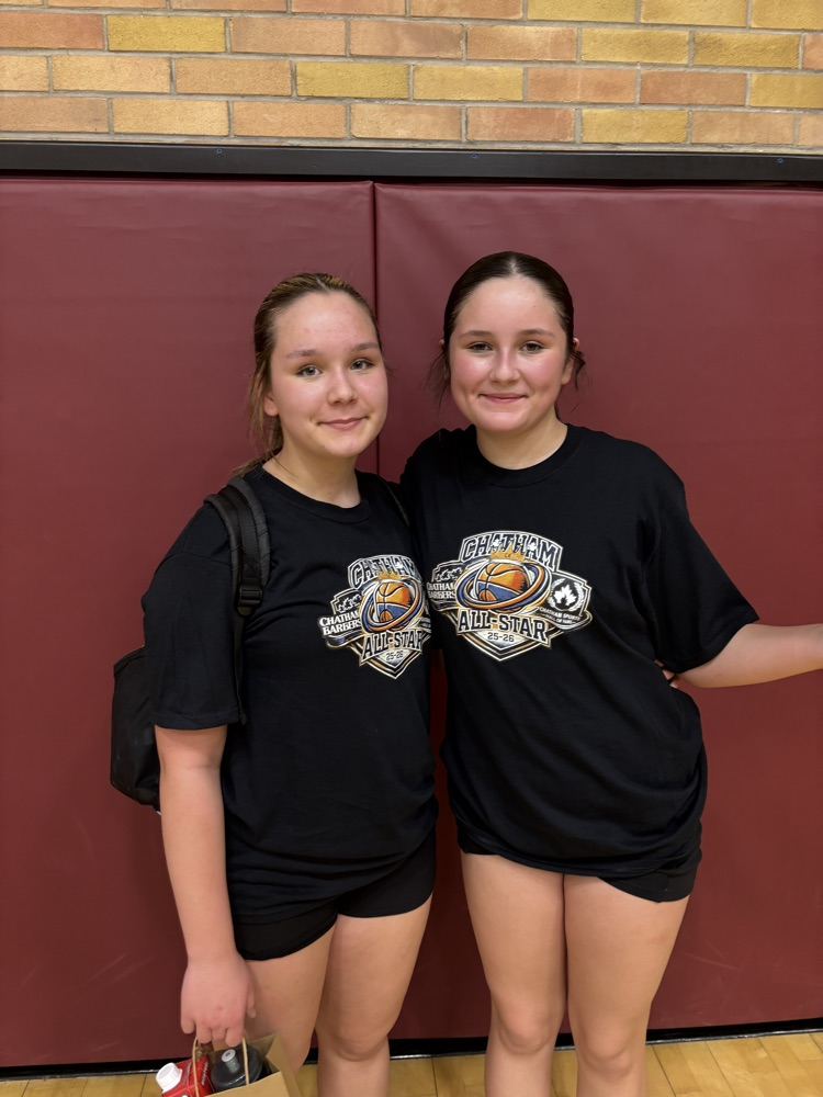 two female students posing after a basketball game