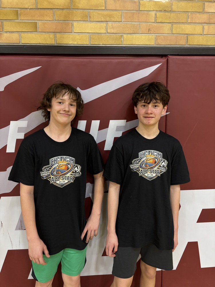 Two male students posing after a basketball game