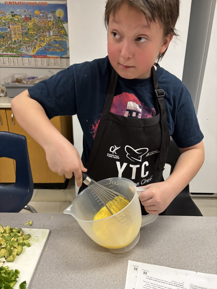 Student whipping up eggs