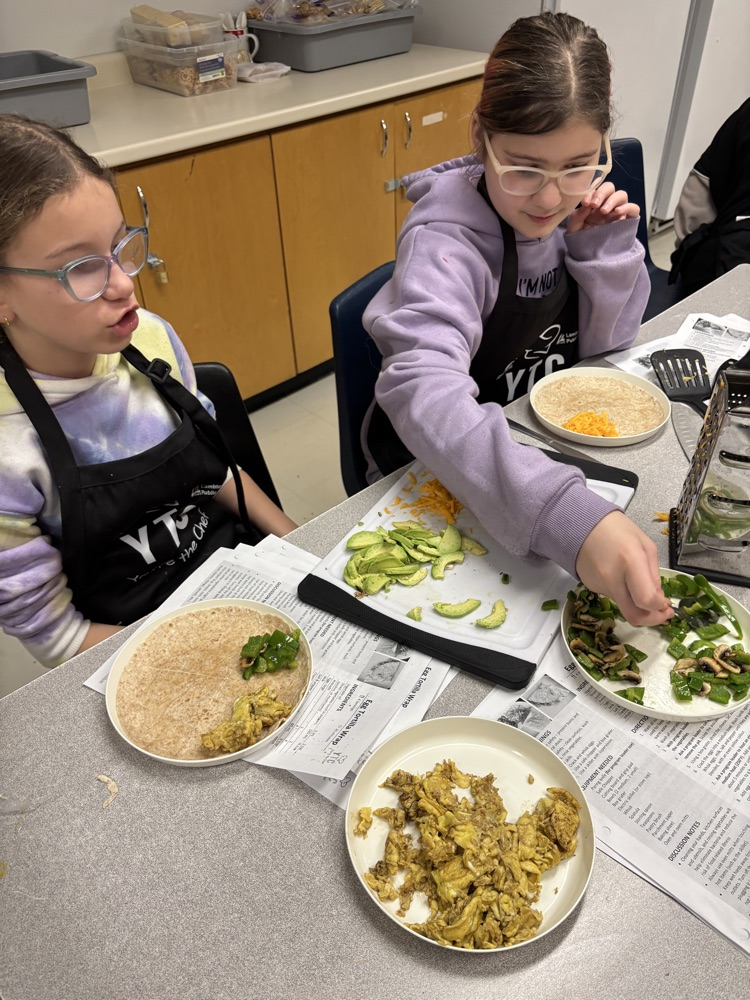 students adding ingredients to their quesadilla