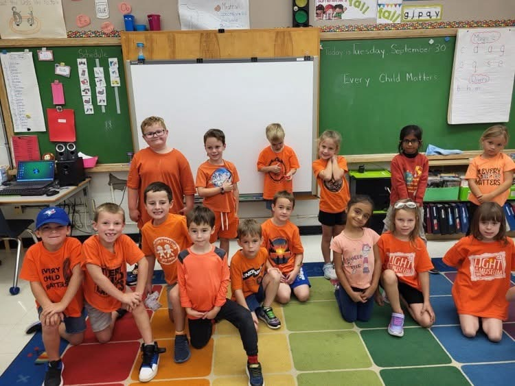group photo wearing orange shirts