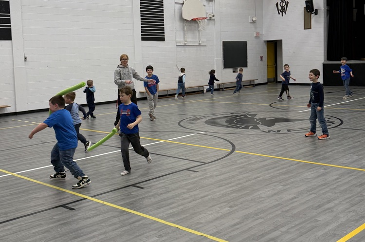 playing a game of noodle tag in the gym