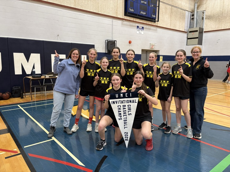 girls basketball team standing together after they win a tournament