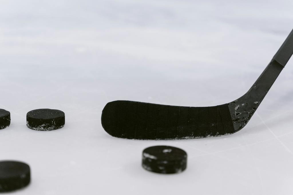 Hockey Puck on Ice with Hockey Stick