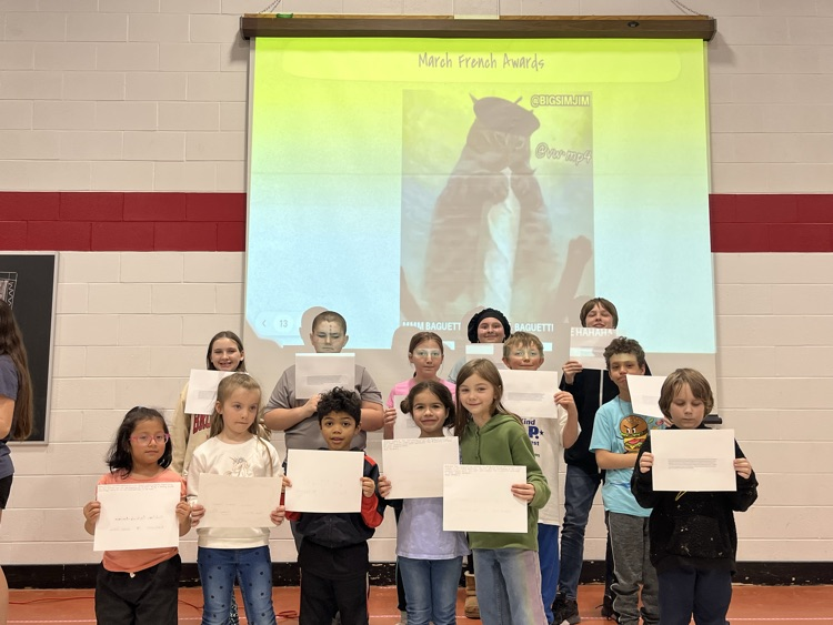students in a group, holding up certificates 