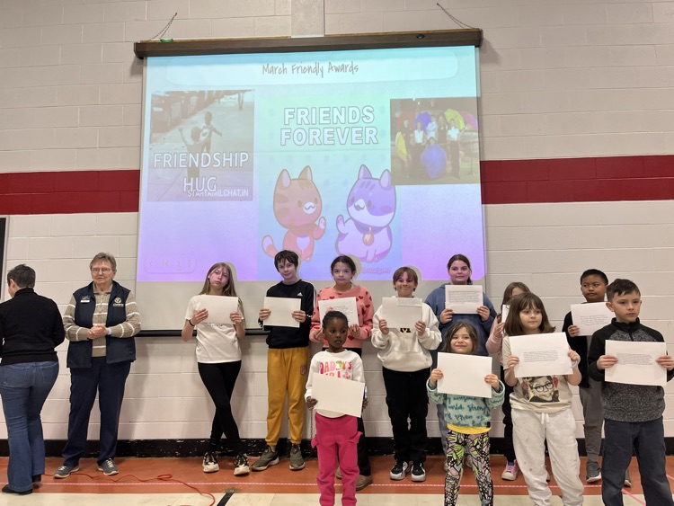 students in a group, holding up certificates 