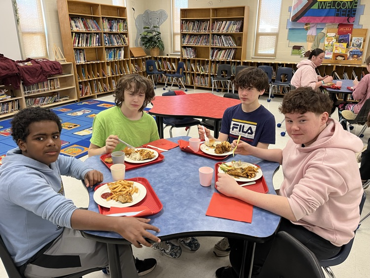 Students sitting at a table, enjoying lunch