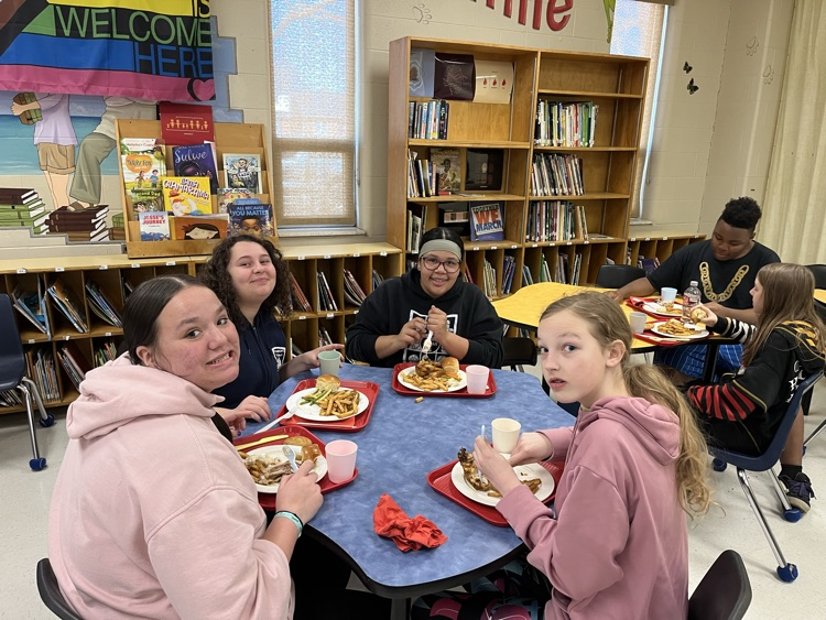 Student sitting at a table enjoying
