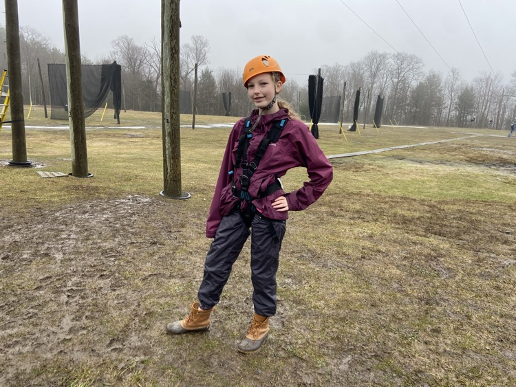 student geared up for high rope course