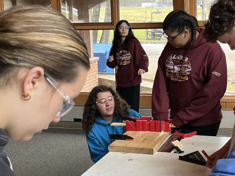students using a mitre box to cut
