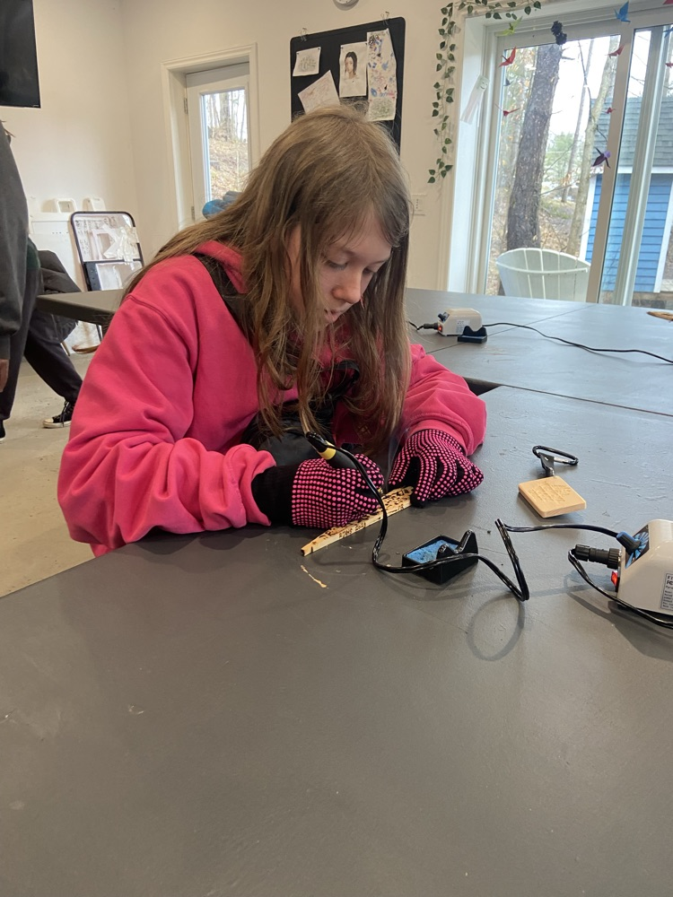 Student using a wood carving kit