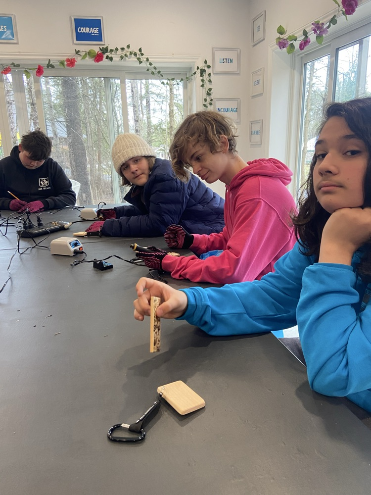 Student using a wood carving kit to make