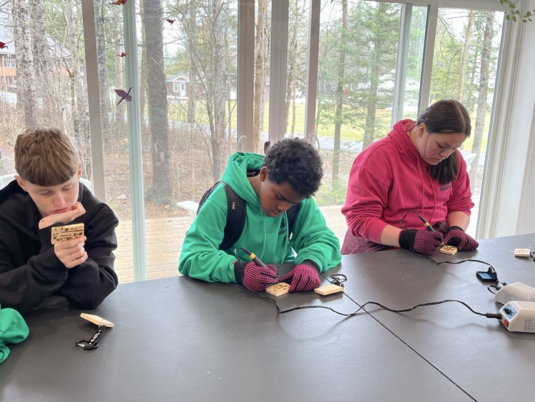 Students working with wood carving kits