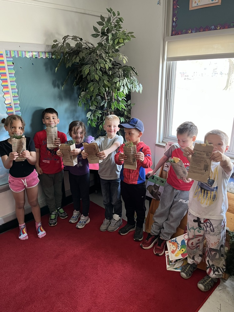 students holding tree saplings