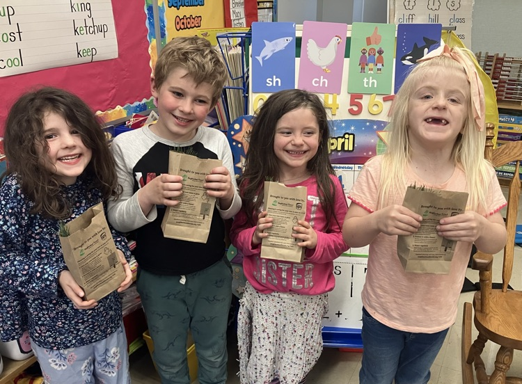Students holding tree saplings
