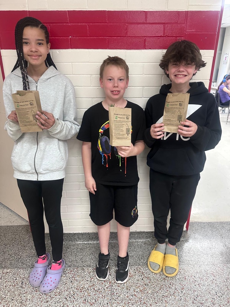 Students holding tree saplings
