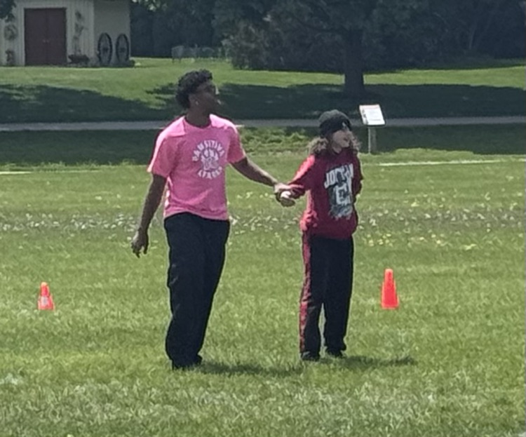 Children playing flag tag in a sports field
