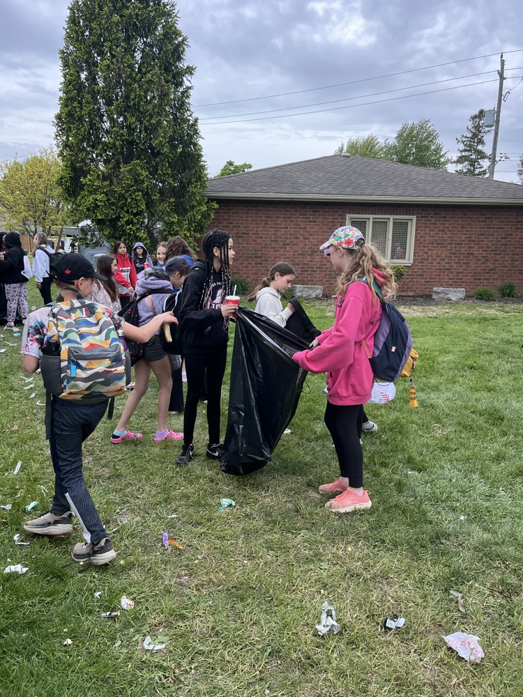 Students cleaning up garbage from the local Ball diamond