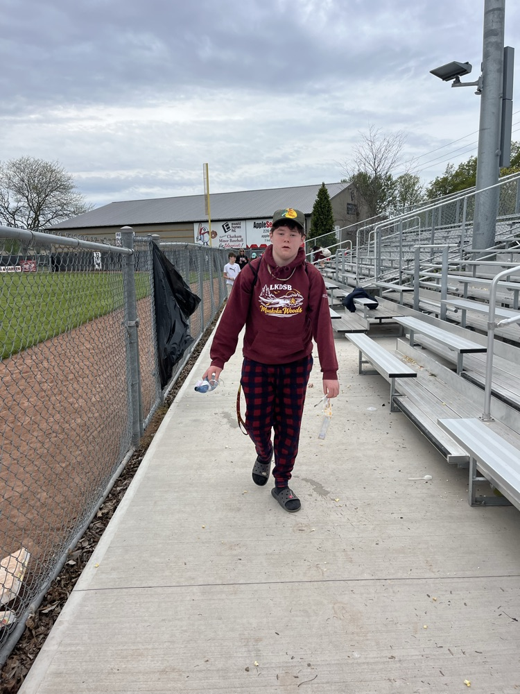Students cleaning up garbage from the local Ball diamond