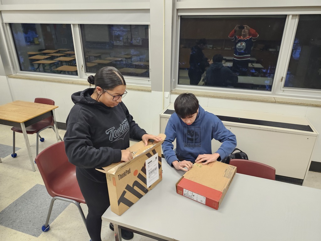Mya and Blake opening their computers
