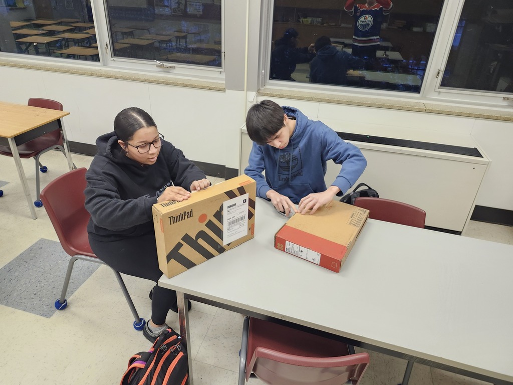 Mya and Blake opening their computers