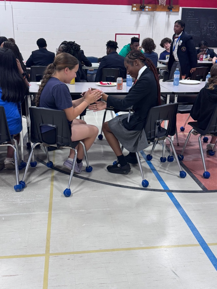 students playing a clapping game with one another