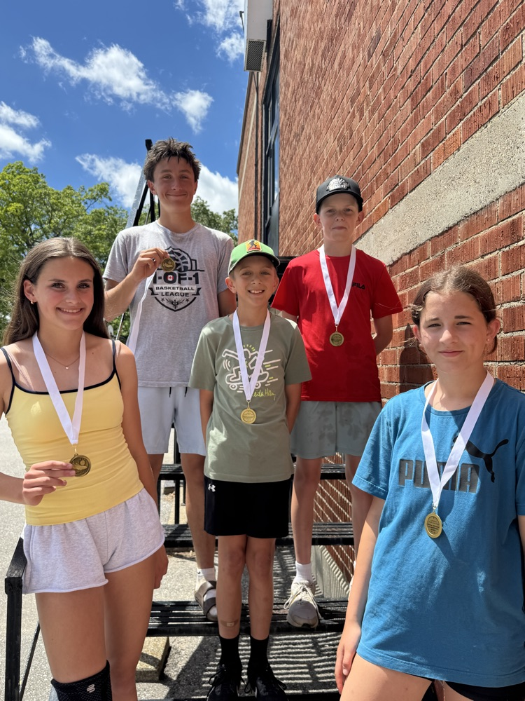 smiling students with medals 